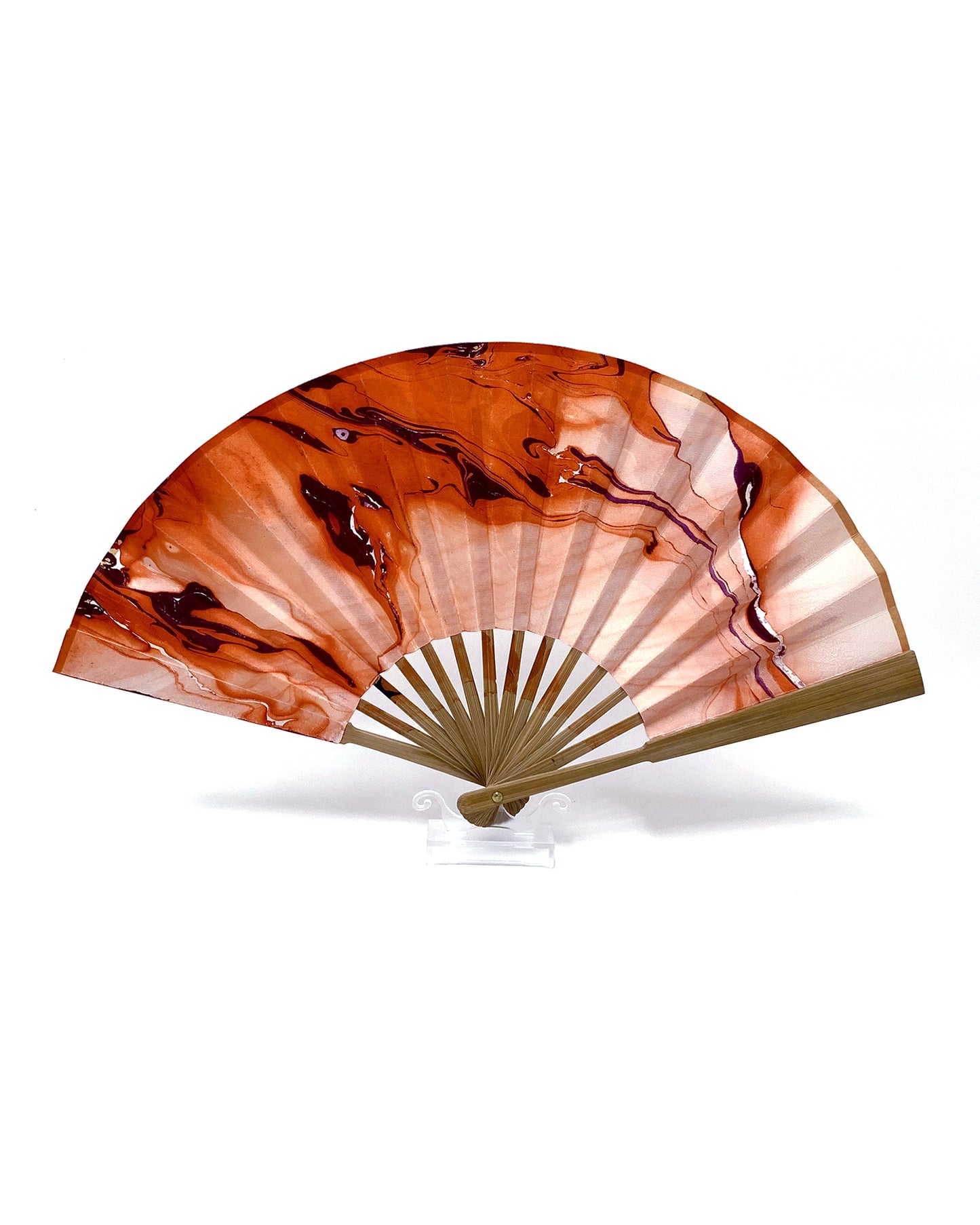 Back view of LanHeal 'Eerie Eyes' handmade fan, fully opened on a white background, with an orange backdrop and purple lines and eye-like oval.